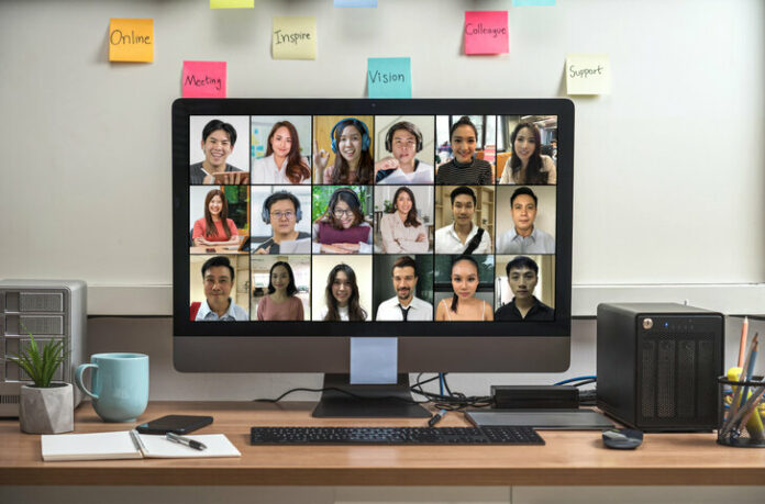 Computer desktop with Stationery and device showing the diversity people with their friend via video conference